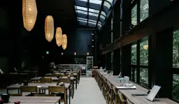 Sophisticated wood interior with modern seating by Glee Hospitality